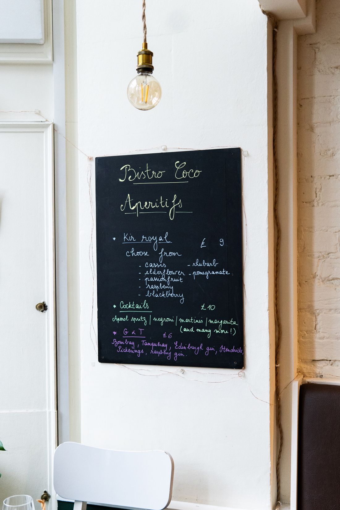 Bistro coco menu hanging on a wall