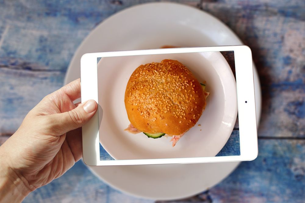 iPad above a plate of food, top down