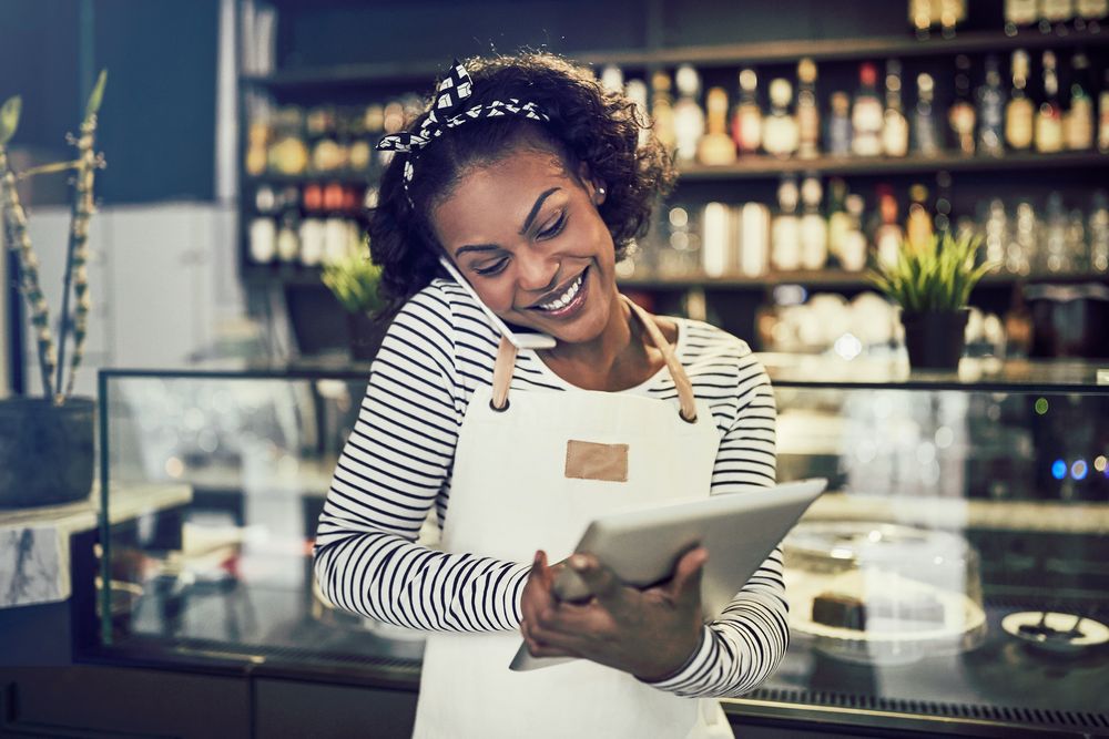 Waiter on the phone with an iPad