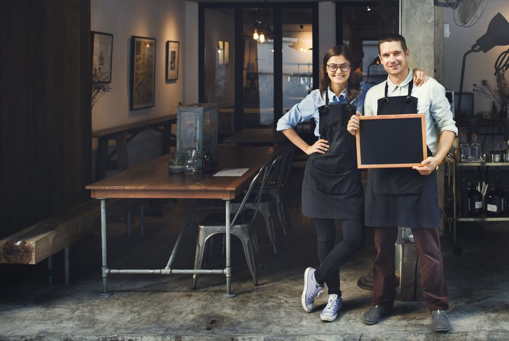Waiters posing outside a cafe