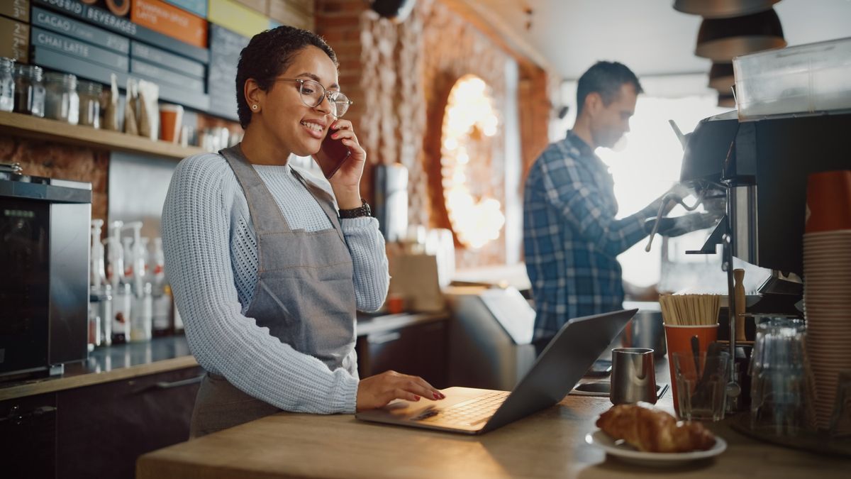 Staff taking a booking by phone at a laptop